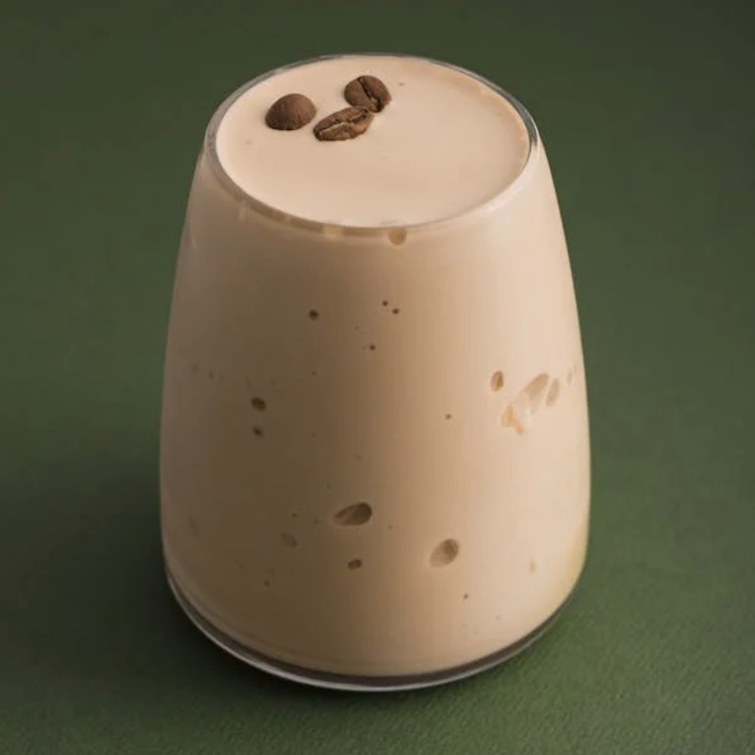 A glass filled with a creamy vanilla drink infused with top quality Jamaican coffee