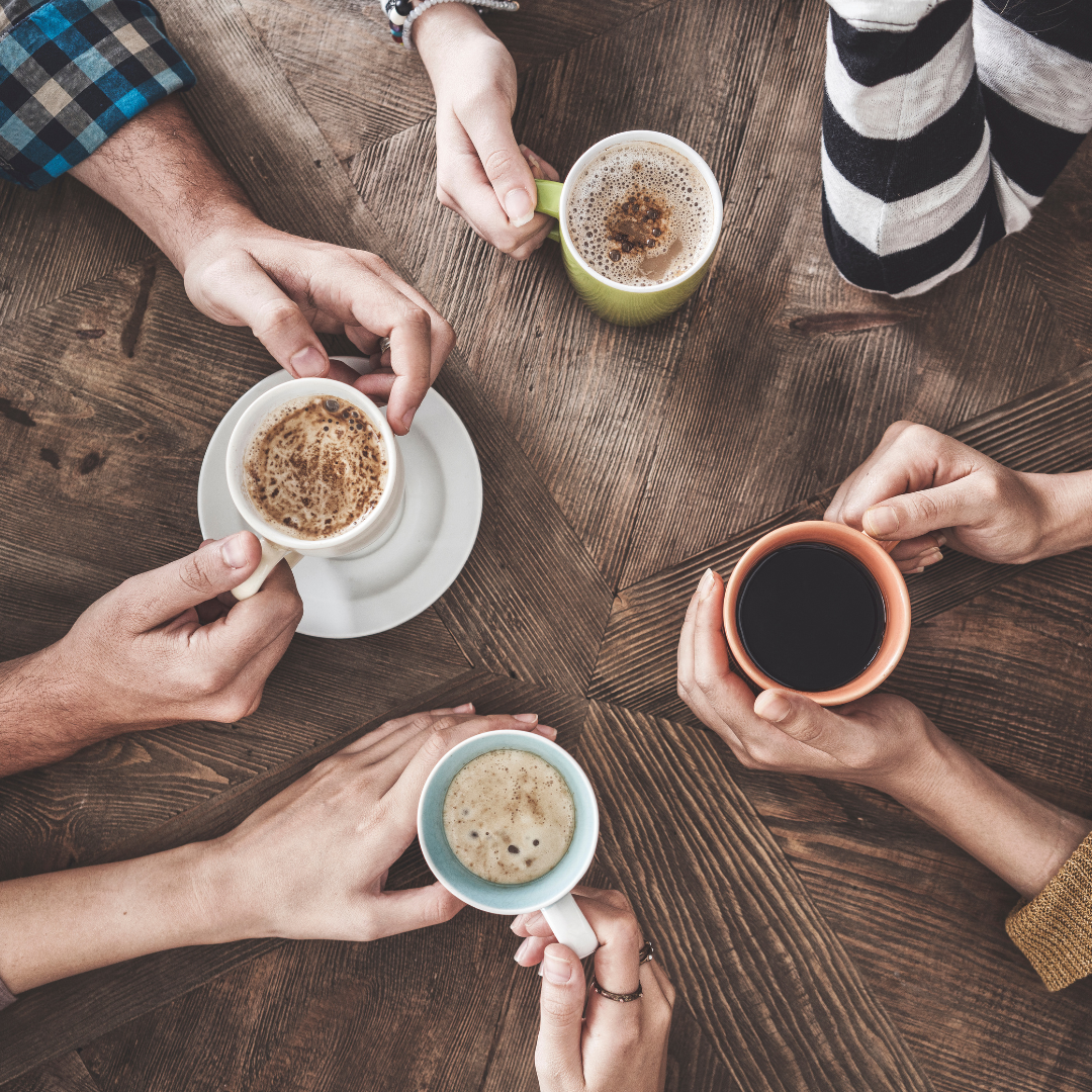 A photo taken from above showing four friends having coffee together