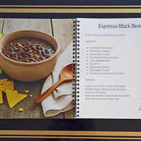 Xaymaca Coffee Traders Recipe book page for Espresso Black Bean Soup with a bowl of soup, tortilla chips, and avocado on a wooden surface.