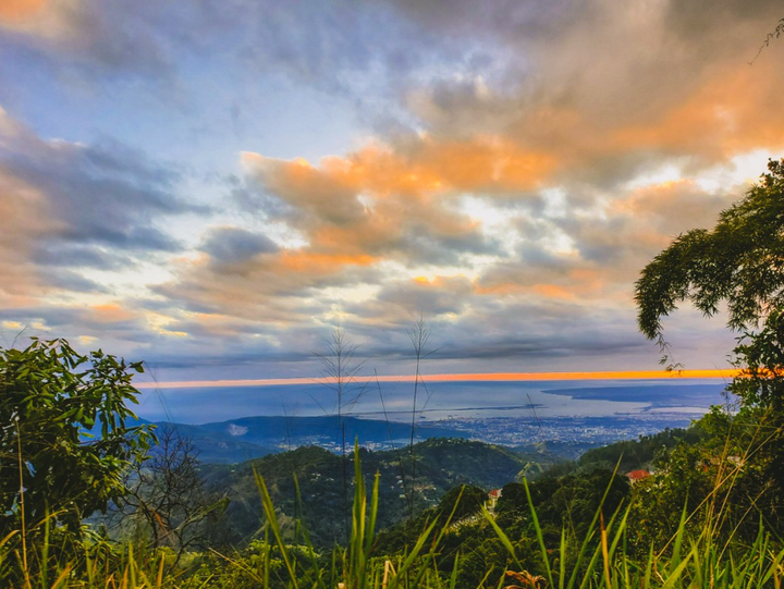 Photo of a sunset over the Jamaica blue mountains, home of Jamaican coffee