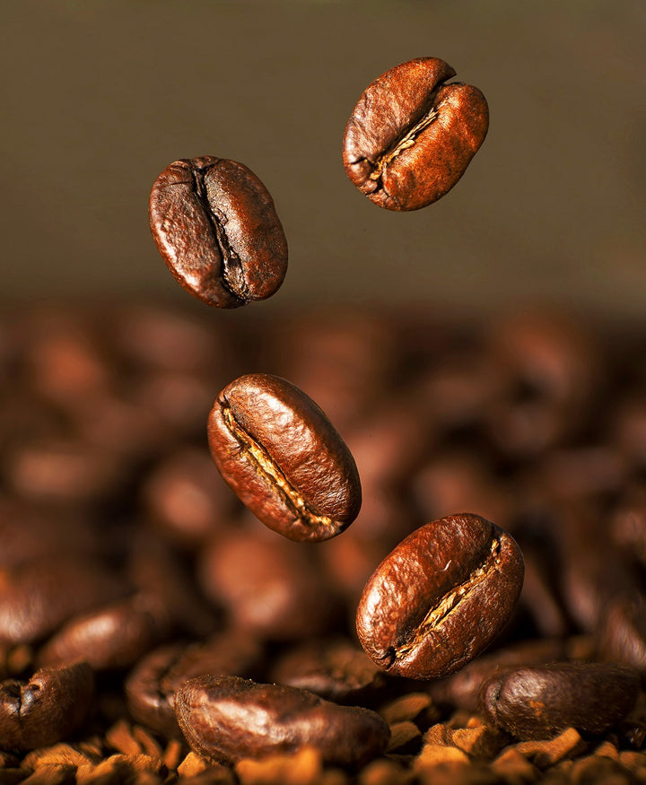 Photo of quality coffee beans from Jamaca falling into a container
