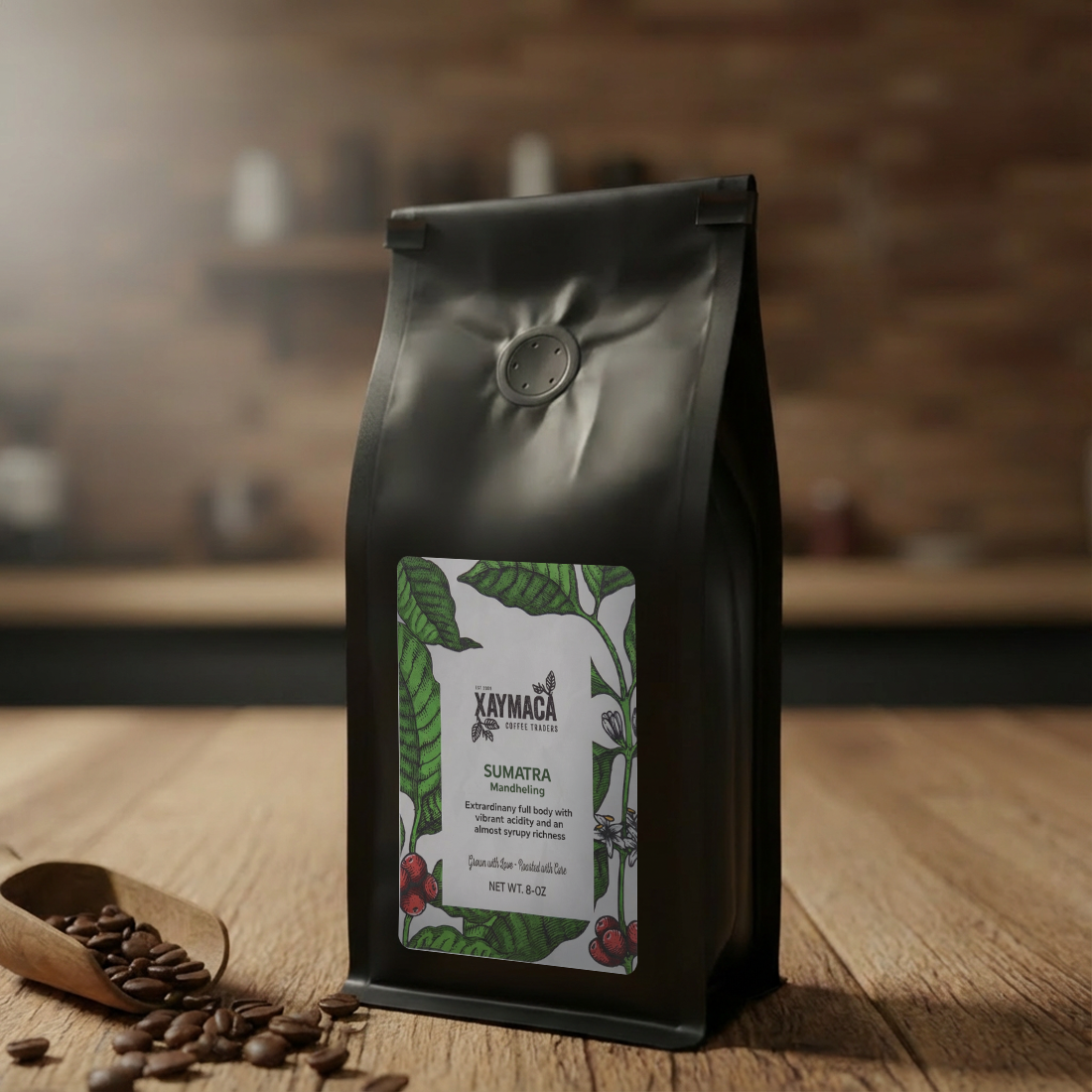 Kaymaca Sumatra coffee bag on a wooden surface with coffee beans and a scoop.